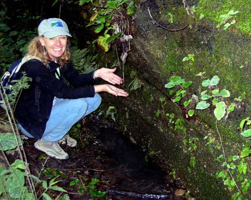 Barbara Dye samples the spring water.